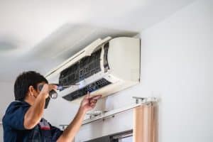 Green Home Solution technician is installing a new ac unit at roof