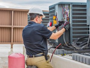 hvac technician is repairing a heat pump in vancouver